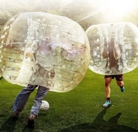guys playing soccer in bubbles