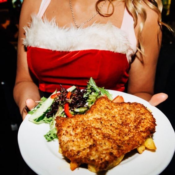 a girl holding a chicken schnitzel